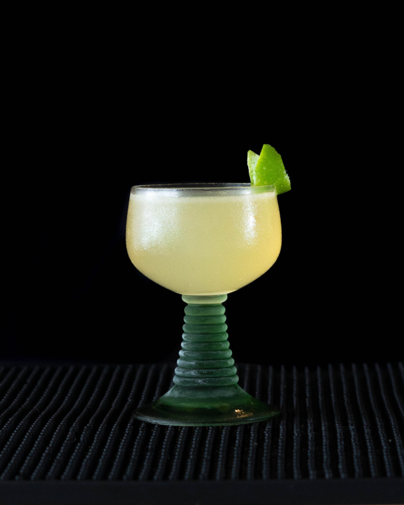 The Banana Daiquiri on a bartop with a black background