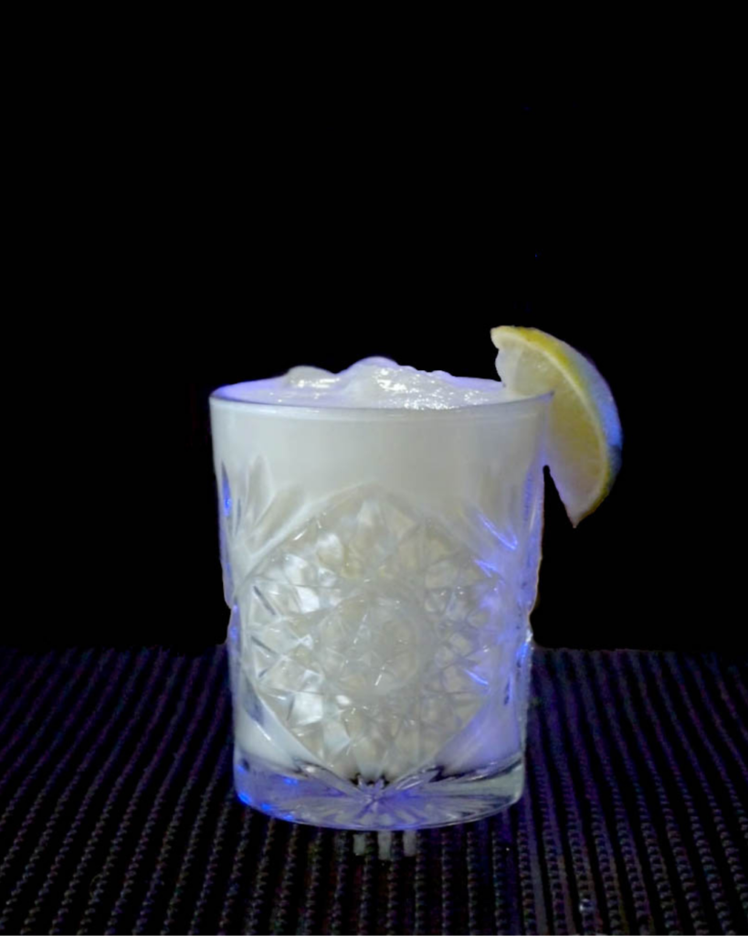 Brazilian Lemonade on a bar countertop with a black background