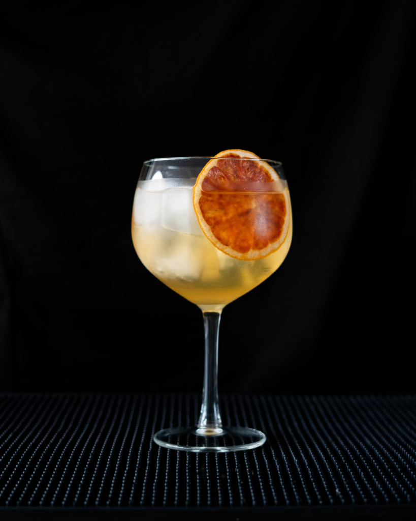 The Grand Tonic on a bar top with a black ground.