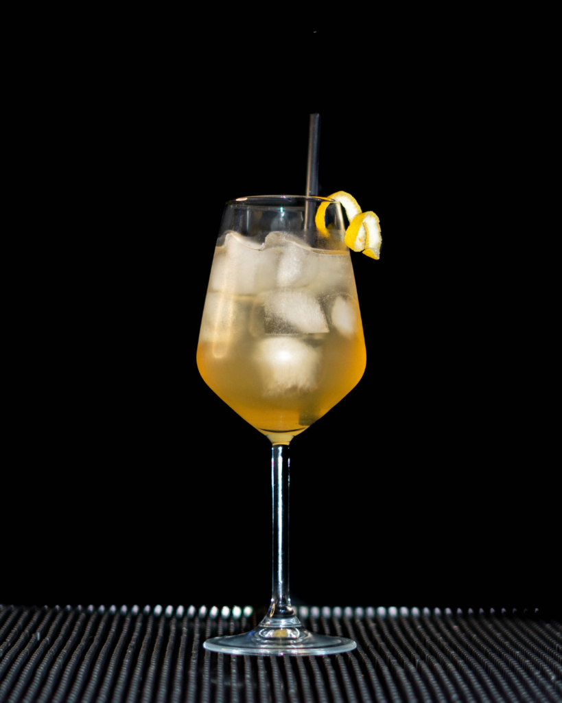 Martini Floreale Spritz served in a wine glass with a black background