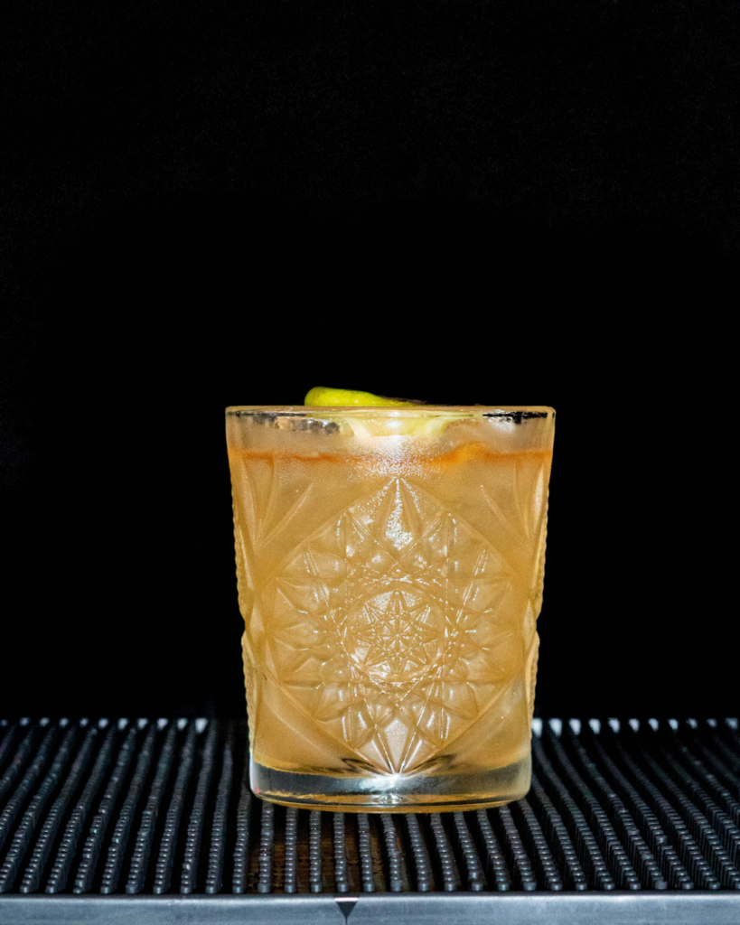 The Mai Tai on a bartop with a black background