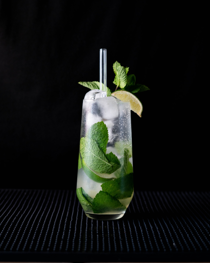 The Mojito on a bar countertop with a black background