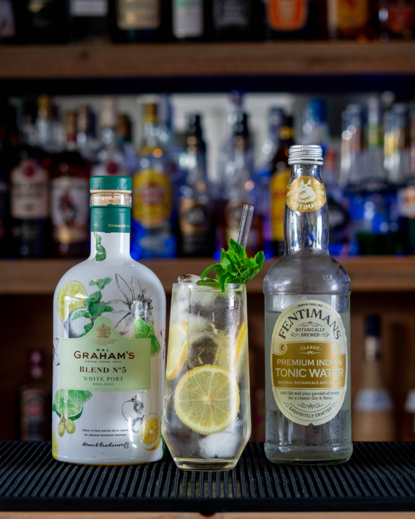 The Porto Tonico (White) on a bar countertop, surrounded by its ingredients.