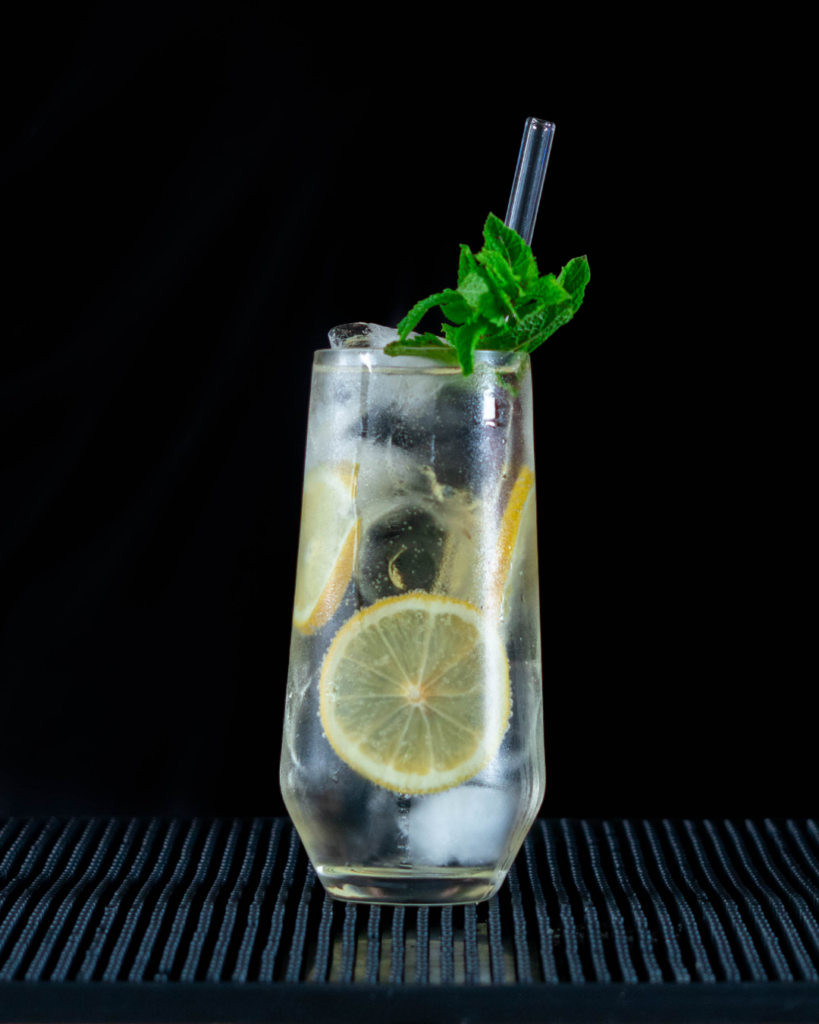 The Porto Tonico (White) on a bar countertop with a black background.