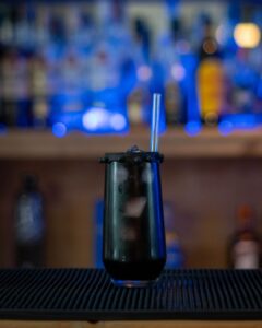 The Black Widow (Halloween themed drink) cocktail on a home bartop.