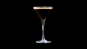 The Espresso Martini on a home bartop with a black background.
