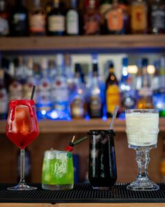 The Vampire's Kiss, The Hallogreen, The Black Widow and the Skulltini (Halloween themed drinks) cocktails on a home bartop.