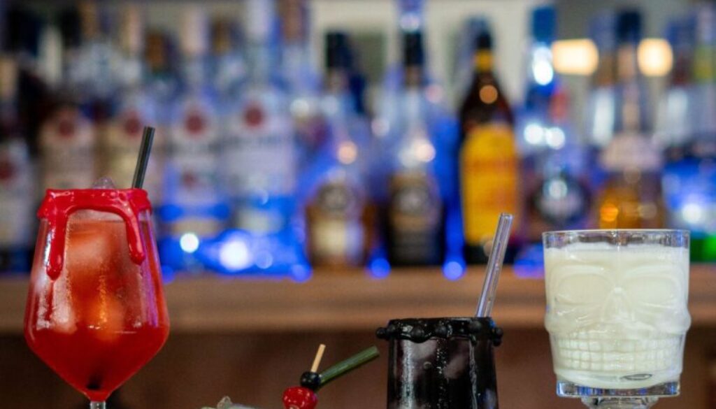 The Vampire's Kiss, The Hallogreen, The Black Widow and the Skulltini (Halloween themed drinks) cocktails on a home bartop.