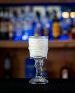 The Skulltini (Halloween themed drink) cocktail on a home bartop.