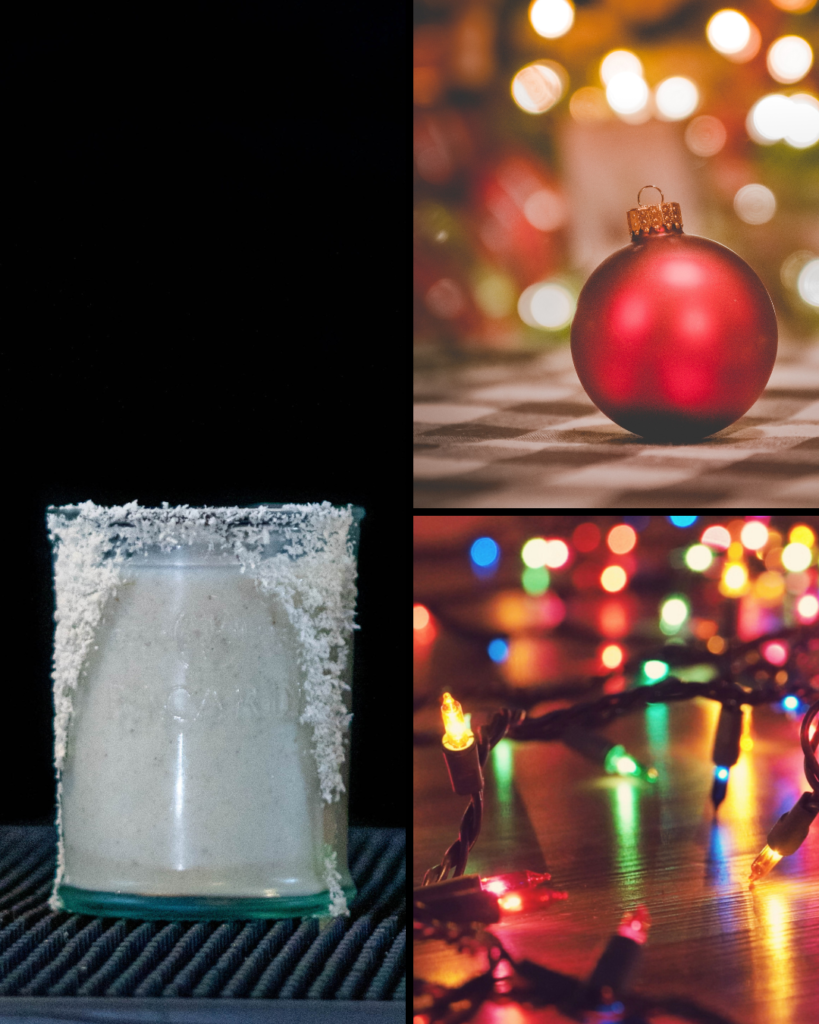 Coquito garnished with shredded coconut flakes and Christmas ornaments and collared lights.