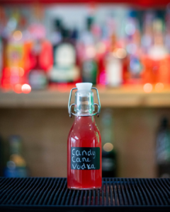 Homemade Candy Cane Liqueur on a home bar top