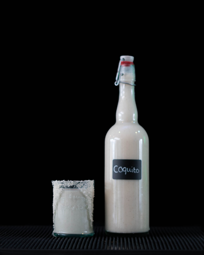 The Coquito on a bartop with a black background