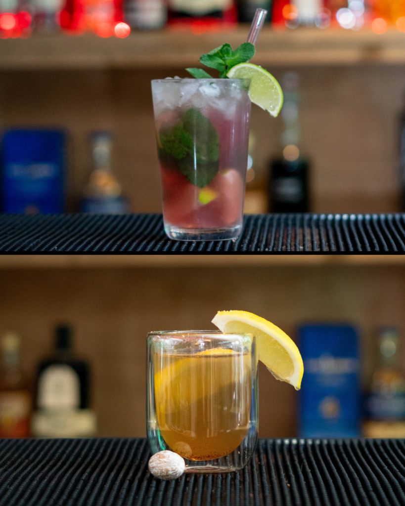 The Cranberry Mojito & The Nutmeg Hot Toddy, both on a bar top.