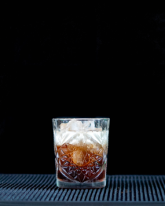 The Gingerbread White Russian on a bartop with a black background