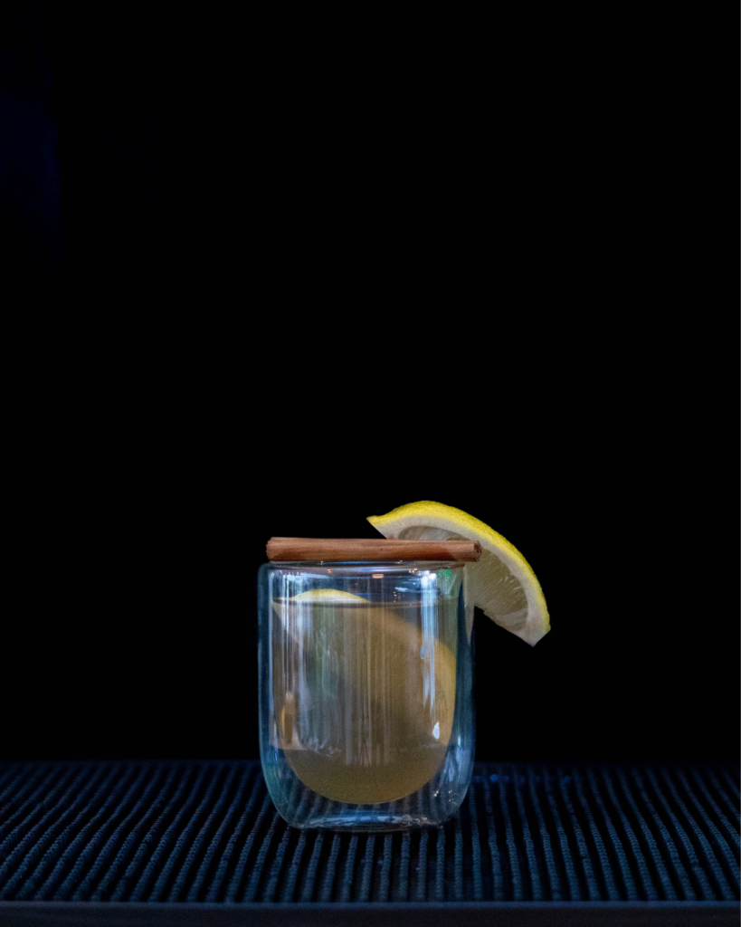 The Hot Toddy on a bar top with a black background