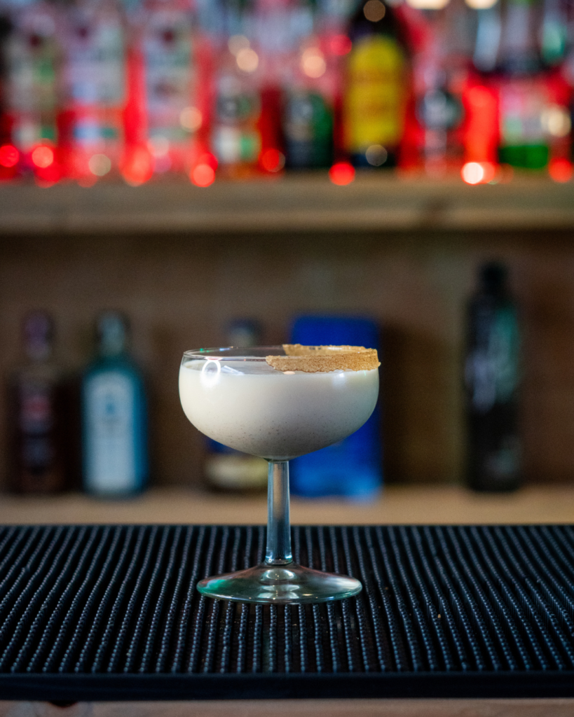 The Spiced Eggnog Martini on a bar top.