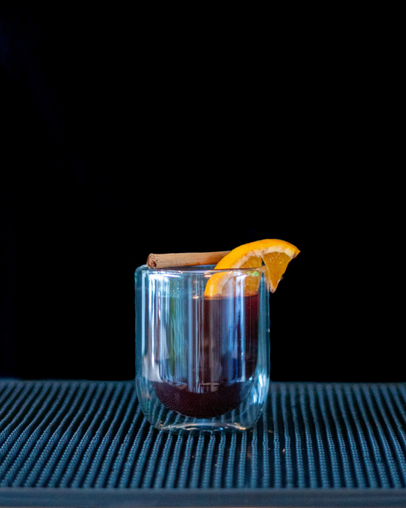 Spiced Mulled Wine on a bartop with a black background