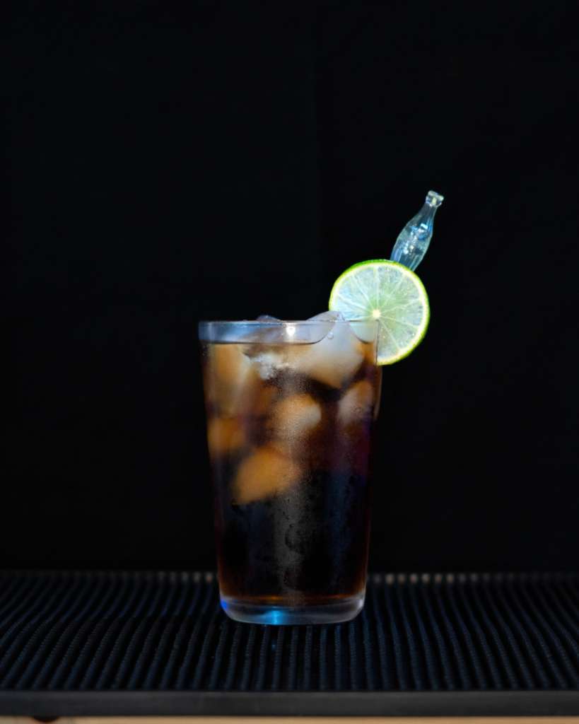 The Baristo By Night on a bar top with a black background.