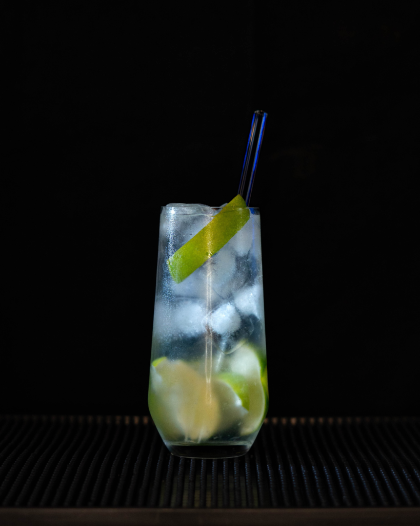 The Gin Rickey on a bartop with a black background.