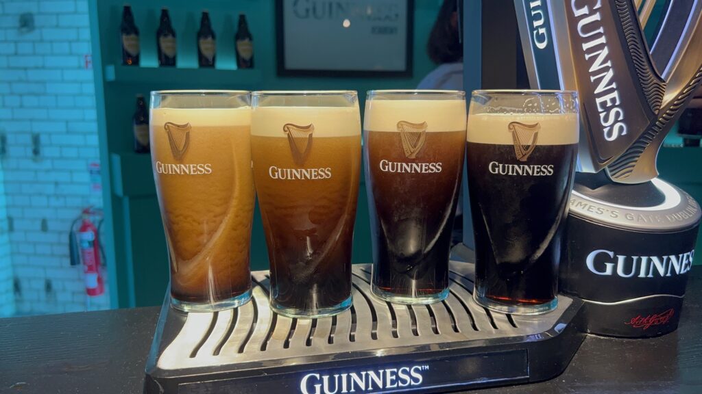 4 pints of Guinness on a bartop. Left to right light to dark.