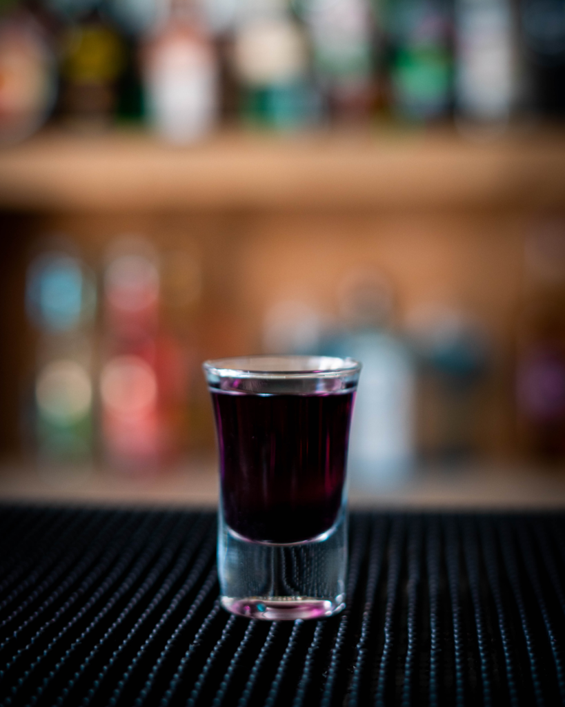 The Purple or Tropical Mystery Shot on a bar top.