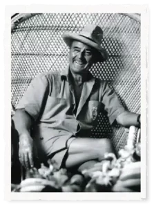 Donn The Beachcomber sitting on a chair in a black and white photo.