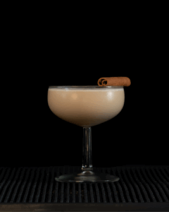 The Cinnamon Roll Martini on a home bartop with a black background