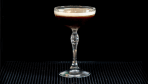 The Dominicana drink on a home bartop with a black background