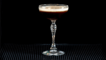 The Dominicana drink on a home bartop with a black background