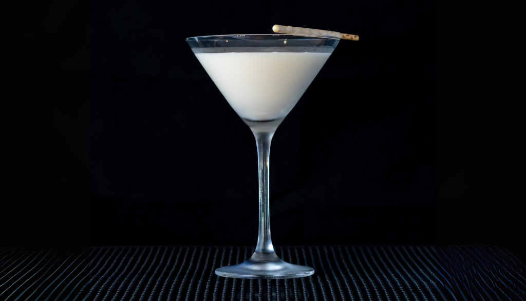 The White Chocolate Martini on a home bartop with a black background.