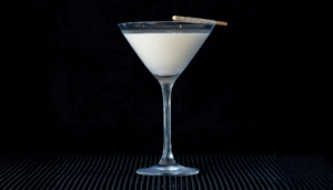 The White Chocolate Martini on a home bartop with a black background.
