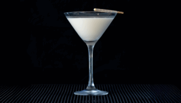 The White Chocolate Martini on a home bartop with a black background.