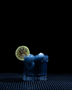The Black Margarita on a home bartop with an all black background.