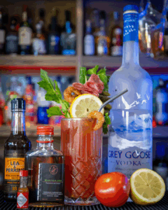 The Bloody Mary on a home bartop, surrounded by its ingredients