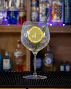 Gin & Tonic: Gordon's London Dry Gin & Schweppes Indian Tonic mixed on a home bartop.