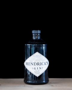 Hendricks Gin Bottle on a home bartop with a black background.