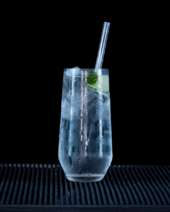 Gin & Tonic: Hendricks Gin & Fever-tree Indian Tonic mixed on a home bartop with a black background.