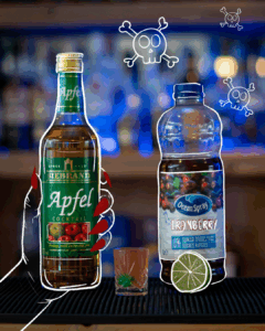 Poisened Apple Halloween Shot surrounded by its ingredients on a home bar top.