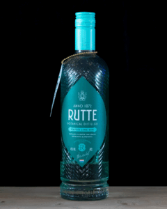 Gin & Tonic: Rutte Kaffir Lime Gin & Fever-tree Mediterranean Tonic mixed on a home bartop with a black background..