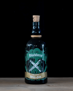 Black Forest Wild Creative Gin on a home bartop with a black background.