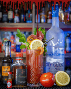 The Bloody Mary on a home bartop, surrounded by its ingredients