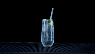 Gin & Tonic: Hendricks Gin & Fever-tree Indian Tonic mixed on a home bartop with a black background.