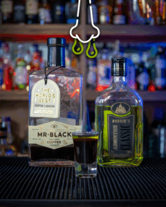 Snot Shot Halloween with its ingredients on a home bar top.