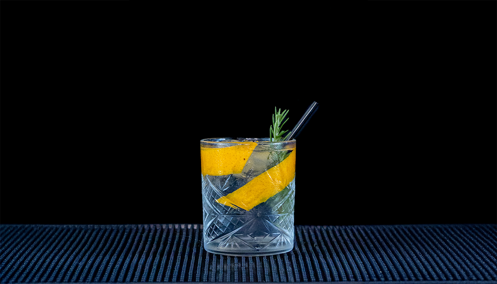 Black Forest Wild Gin & Fever-Tree Mediterranean Tonic Water mixed on a home bartop with a black background.