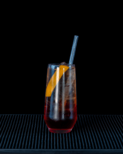 the Americano cocktail on a home bartop with a back background.