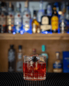 the Boulevardier cocktail on a home bartop.