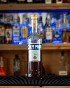A bottle of Campari, Italian Bitter Aperativo, on a home bar top.