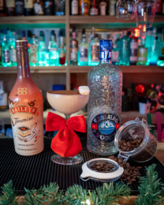 The Baileys Tiramisu Martini on a home bartop surrounded by its ingredients