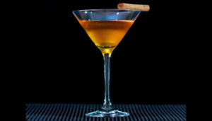 The Gingerbread Martini on a bartop with a black background