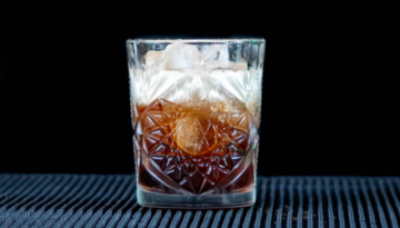 The Gingerbread White Russian on a bartop with a black background